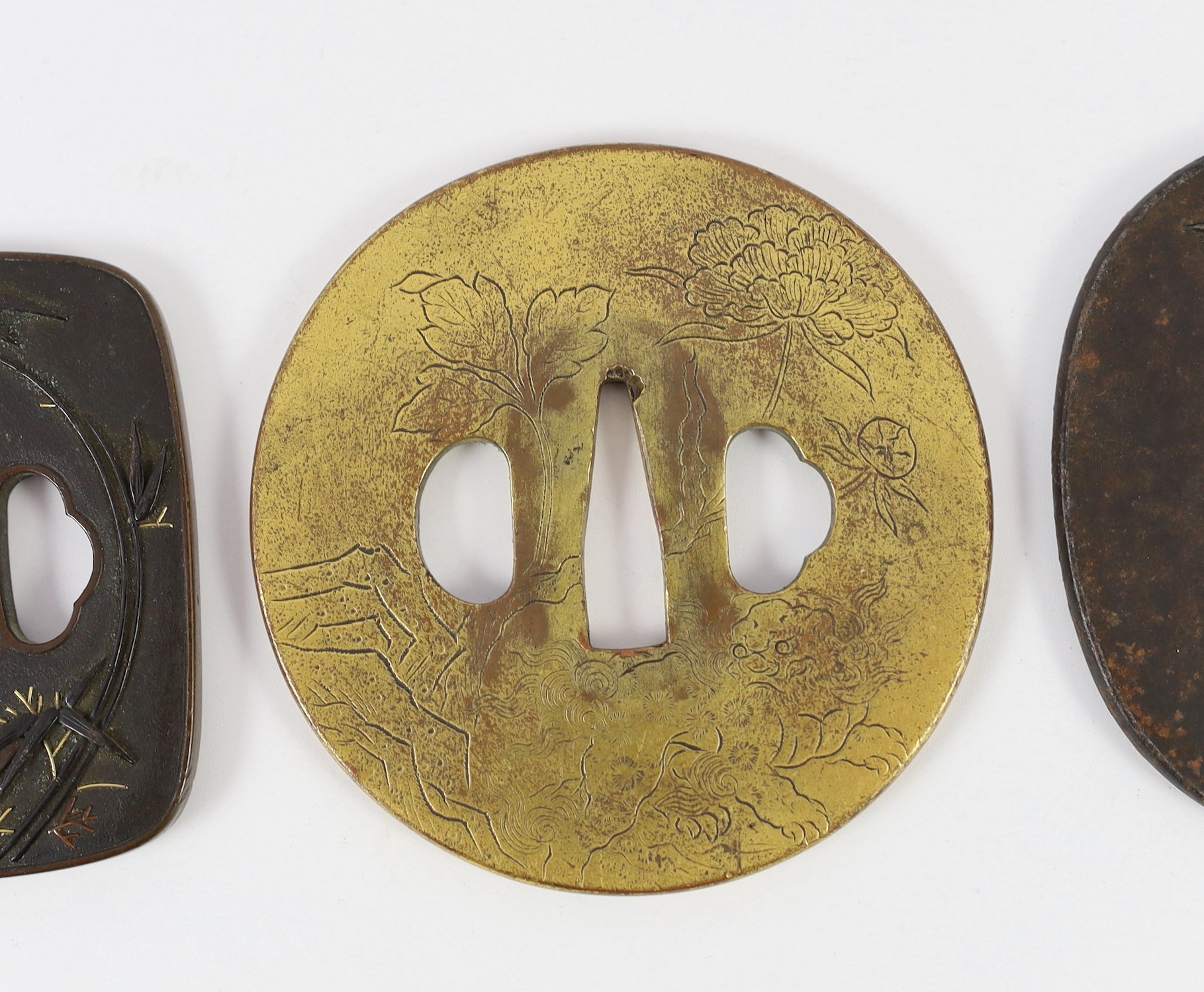 A group of Japanese bronze, iron and mixed metal tsuba and a kozuka knife handle, 19th century